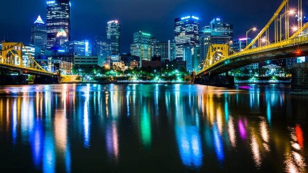 The Pittsburgh skyline reflecting in the Allegheny River at night, seen from the North Shore, in Pittsburgh, Pennsylvania.